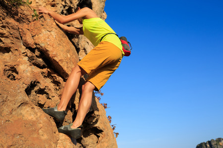 woman rock climber climbing at  cliffの写真素材
