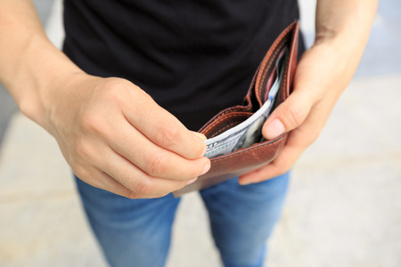 hands taking moeny out of wallet in the cityの写真素材