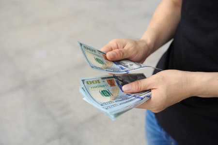woman hands counting money in the city