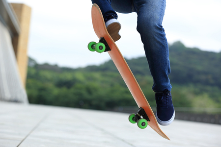 Skateboarder legs skateboarding at cityの写真素材