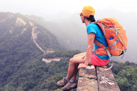 successful woman hiker enjoy the view on the top of great wallの写真素材