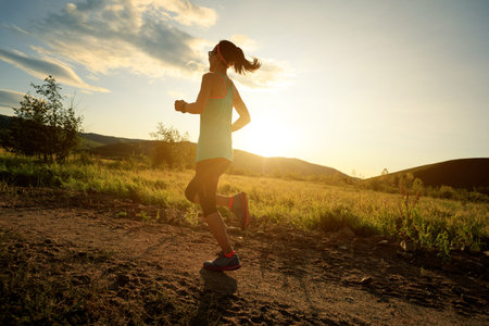 trail runner woman running on forest trail
