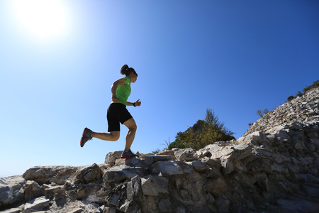 woman trail runner running at mountain topの写真素材
