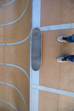 skateboarder ready for skateboarding on skatepark ramp