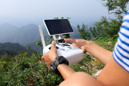 hands use the remote control of drone 