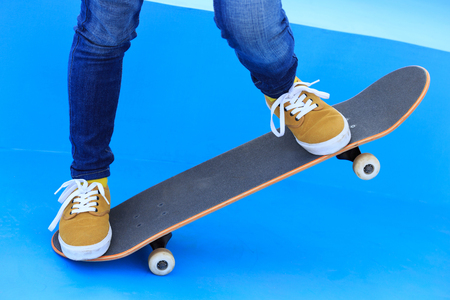 one woman skateboarder legs riding skateboard on skateparkの写真素材