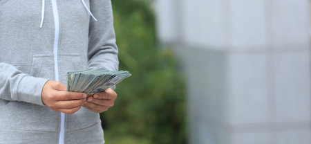 Female hands counting money on blurred background