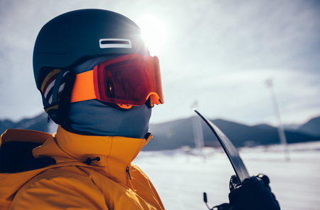 one snowboarder with snowboard looking at the  snowobard piste on winter mountainsの写真素材
