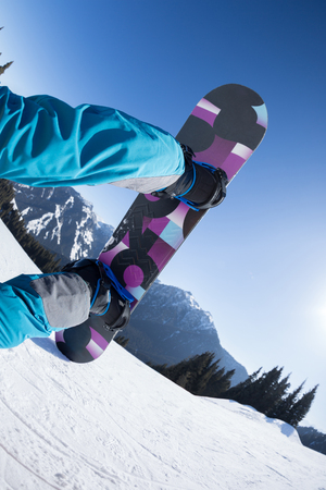 snowboarding legs in winter mountainsの写真素材