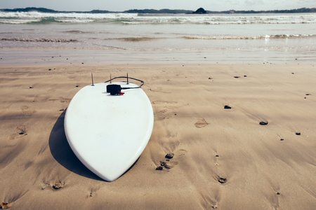White Surfboard with leg leash on beachの写真素材