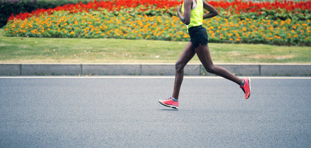 marathon runner running on city road