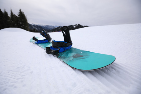  snowboard on ski piste in winter mountainsの写真素材