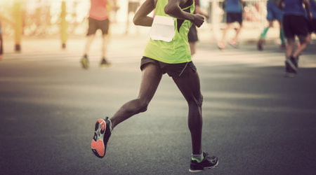 marathon runner legs running on city road
