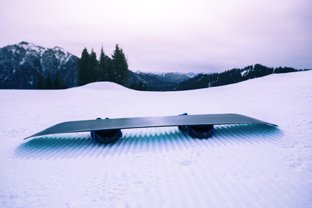  snowboard on ski piste in winter mountainsの写真素材