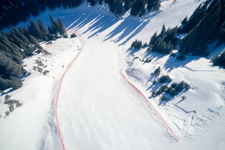 Aerial view of the Alpine skiing and snowboarding piste in mountainsの写真素材