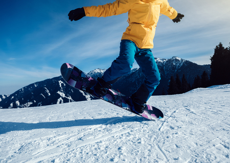 one snowboarder snowboarding jumping winter mountain topの写真素材