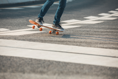 Skateboarder sakteboarding on city streetの写真素材