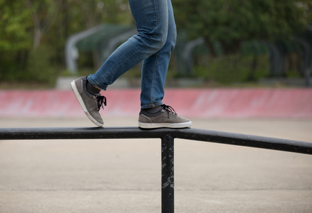 Legs walking on steel pipe with balanceの写真素材
