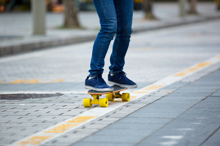 legs skateboarding on ctiy streetの写真素材