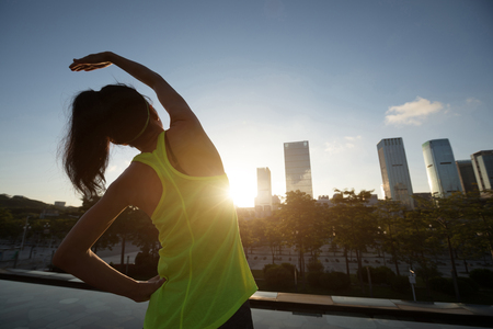 Healthy lifestyle woman runner warming up before runningの写真素材