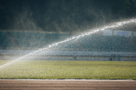Automatic sprinklers watering grassの写真素材