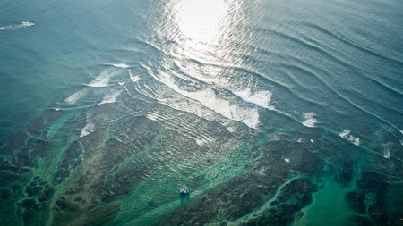 Aerial view of sea wave breaking in the coastの写真素材
