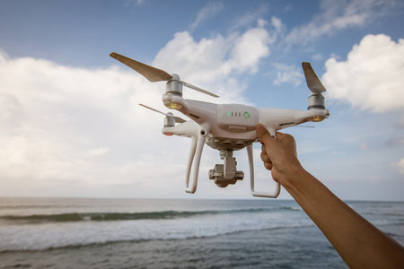 Hand hold drone on seasideの写真素材
