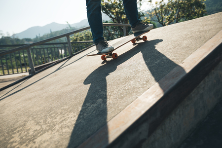 Skateboarder skateboarding at skatepark rampの写真素材