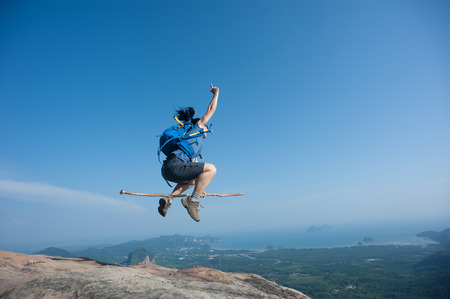 fly with stick on rocky mountain peak, freedom, risk, challenge, success conceptの写真素材