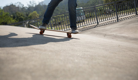 Skateboarder skateboarding at skatepark ramp