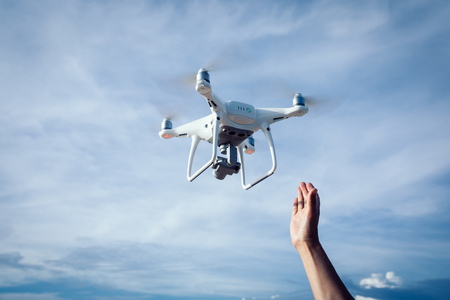 a flying drone which taking photo over seaの写真素材