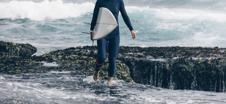 Woman surfer with surfboard going to surf