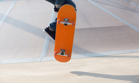 legs skateboarding at skateparkの写真素材