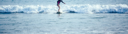 Surfer girl on the surfboard beach