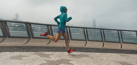 Healthy lifestyle woman runner running on hong kong cityの写真素材