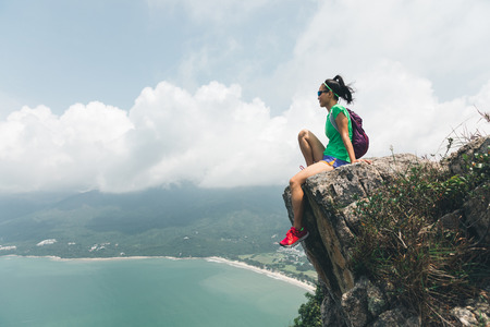 Successful Woman Hiker enjoy the beautiful view In Seaside Mountain Topの写真素材