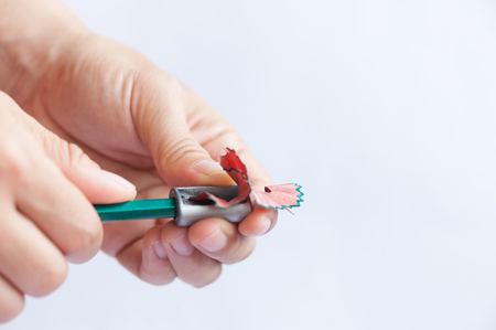 Hands sharpening pencil close-upの写真素材