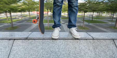 Skateboard on the edge of urban building wall at city