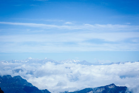 Stunning  landscape with amazing clouds floating between mountains
