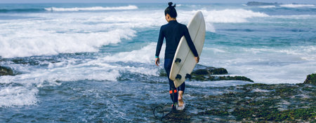 Woman surfer with surfboard going to surf