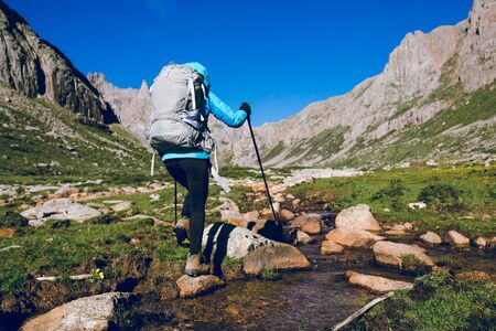 Woman hiker hiking on high altitude mountainsの写真素材