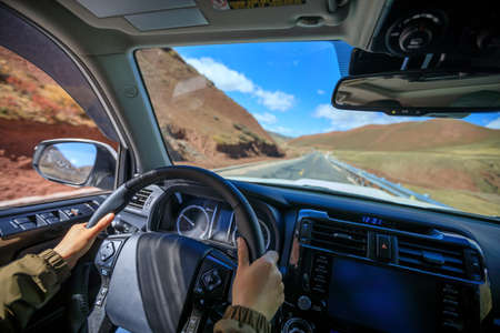Driving off road car on high altitude mountain trail on winter dayの写真素材
