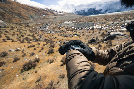 Woman hiker checking  the altitude on smartwatch in winter tibet