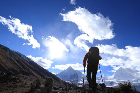 Woman hiker hiking  in winter mountains