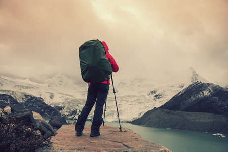 Woman hiker  in winter high altitude mountainsの写真素材