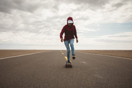 Asian woman skateboarder skateboarding in the wide worldの写真素材