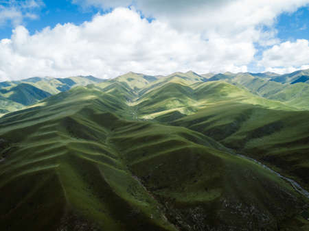 High altitude mountains with grassland landscapeの写真素材