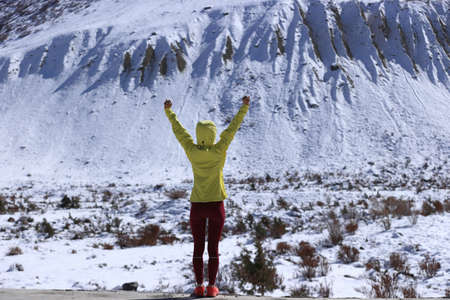 Woman trail runner  cross country running  in winter mountainsの写真素材