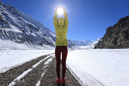 Woman trail runner  cross country running  in winter mountains