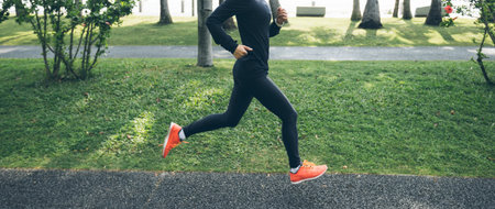 Fitness woman running training for marathon on sunny tropical park trailの写真素材